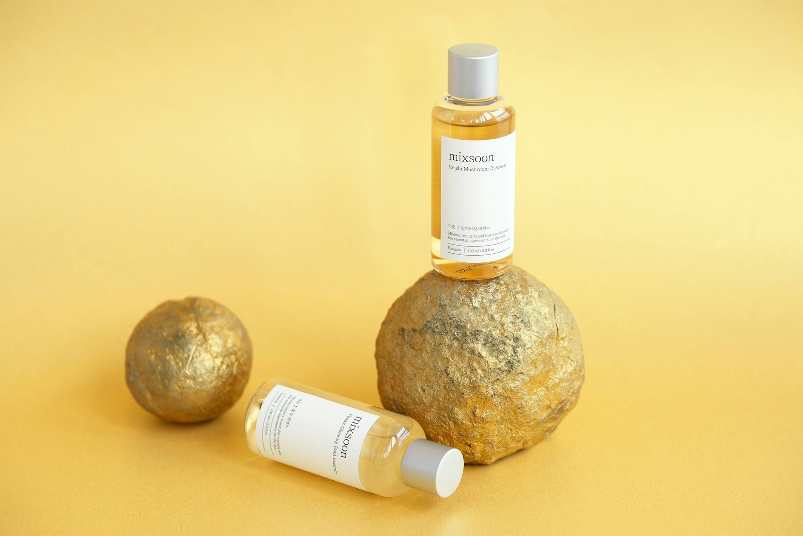Two Mixsoon skincare products on a yellow background